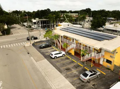 an aerial view of a building with cars parked in a parking lot at Sinbad Motel in Miami