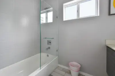 a white bathroom with a tub and a shower at Wynwood Amazing Condo Sleeps 5 Close to Beach in Miami