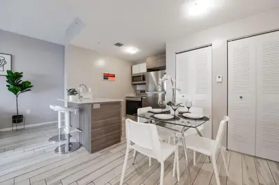 a kitchen and dining room with a table and chairs at Wynwood Amazing Condo Sleeps 5 Close to Beach in Miami