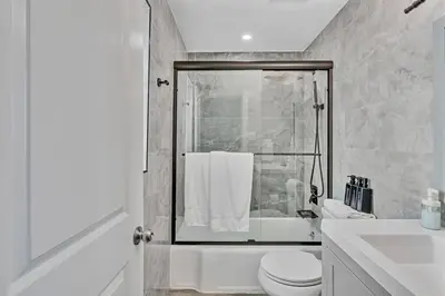 a bathroom with a shower and a toilet and a sink at Panoramic beachfront Suite in Hollywood