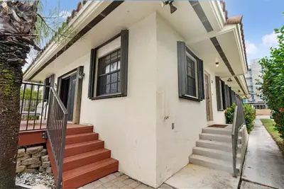 a white house with stairs and windows at DOWNTOWN LAS OLAS WATERFRONT HOME UPDATED UNIT in Fort Lauderdale