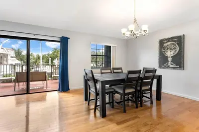 a dining room with a black table and black chairs at DOWNTOWN LAS OLAS WATERFRONT HOME UPDATED UNIT in Fort Lauderdale