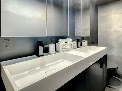 a bathroom with a large white sink in it at CasaGrandeSouthBeach by AmericanVacationLiving 6BR in Miami Beach