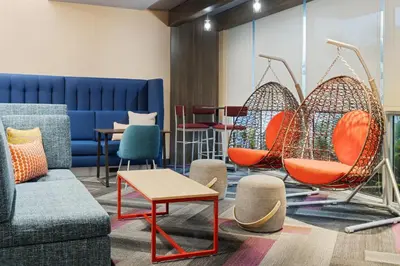 a living room with chairs and a couch at Tru By Hilton Miramar in Miramar