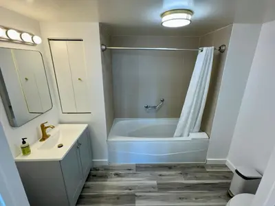 a bathroom with a tub and a toilet and a sink at Balcony Ocean View ! Pool - WiFi - Gym - Parking in Miami
