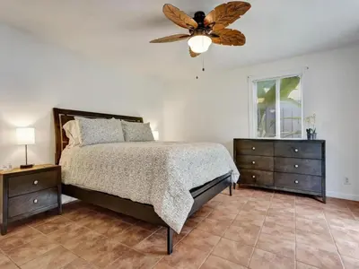 a bedroom with a bed and a ceiling fan at 3 min. walk to Wilton Drive, pool and huge yard in Fort Lauderdale