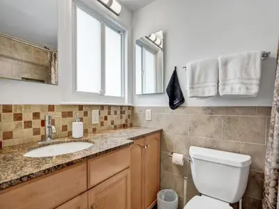 a bathroom with a toilet and a sink at 3 min. walk to Wilton Drive, pool and huge yard in Fort Lauderdale