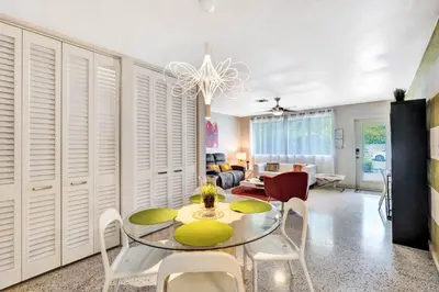 a dining room with a glass table and chairs at 3bed 2bath with pool, 5 min. walk to food and fun in Fort Lauderdale