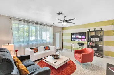 a living room with a couch and a table at 3bed 2bath with pool, 5 min. walk to food and fun in Fort Lauderdale