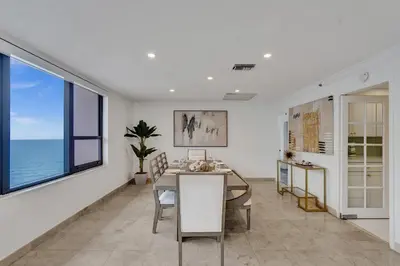 a dining room with a table and a view of the ocean at Ocean View 2BD Penthouse Beach Service PH-6 in Miami Beach