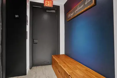 an exit sign above a door in a room at Awesome Ocean View Modern Condo Pool Shuttle in Hallandale Beach