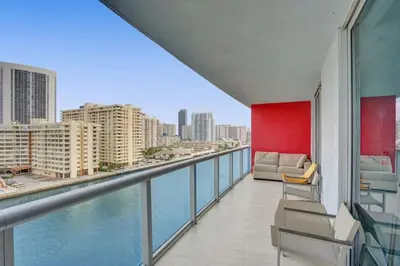 a balcony with a view of the water at Awesome Ocean View Modern Condo Pool Shuttle in Hallandale Beach