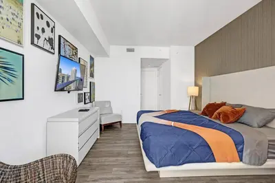 a bedroom with a bed and a desk and a chair at Luxury 2BR 2BA Water Front in Hyde Beach Resort in Hollywood