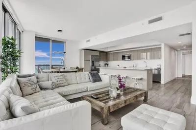 a living room with a couch and a table at Lower Penthouse 3BD 3BA Beach Gym and Pool in Hallandale Beach