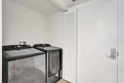 a kitchen with a stove and a washer and dryer at Lower Penthouse 3BD 3BA Beach Gym and Pool in Hallandale Beach