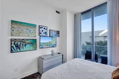 a white bedroom with a bed and a window at Oceanfront Condo Direct Ocean View Beach Access in Hollywood