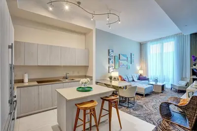a kitchen and living room with a table and chairs at Oceanfront Condo Direct Ocean View Beach Access in Hollywood