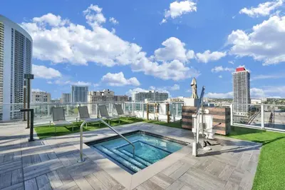 a swimming pool on the roof of a building at Oceanfront Condo Direct Ocean View Beach Access in Hollywood