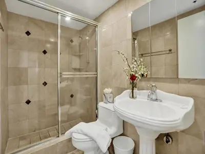 a bathroom with a toilet and a sink and a shower at Beautiful condo in resort beach service 1004 in Miami Beach