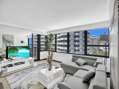 a living room with a couch and a tv at Beautiful condo in resort beach service 1004 in Miami Beach