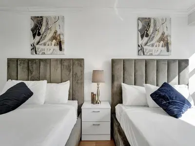 two beds sitting next to each other in a bedroom at Cute Ocean View Condo Beach Service 1217 in Miami Beach