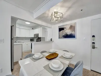 a kitchen and dining room with a table and chairs at Cute Ocean View Condo Beach Service 1217 in Miami Beach