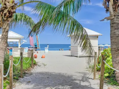 a beach with a palm tree and a volley ball court at Cozy Miami Beach Condo Beach Service 407 in Miami Beach