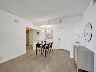 a dining room and living room with a table and chairs at Ocean View Beach Retreat Beach Service 606 in Miami Beach
