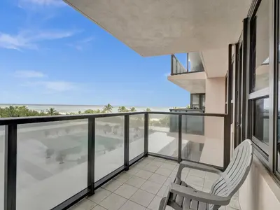 a balcony with a chair and a view of the ocean at Ocean View Beach Retreat Beach Service 606 in Miami Beach