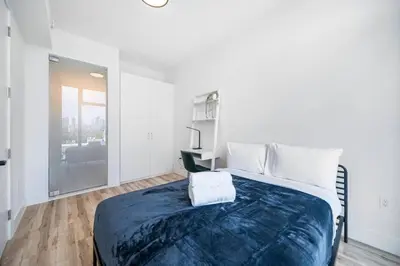 a bedroom with a large bed and a desk at Pastel Apartments in Miami