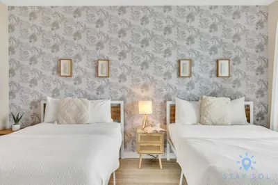 two beds sitting next to each other in a bedroom at Spectacular Apartment with Balcony Near Beach in Hallandale Beach