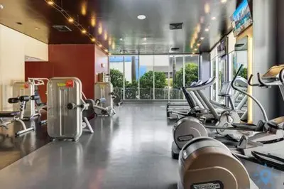 a gym with several chairs and machines in a room at Spectacular Apartment with Balcony Near Beach in Hallandale Beach