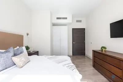 a bedroom with a white bed and a flat screen tv at Best Stay Rooftop Pool Hollywood Beach Boardwalk in Hollywood