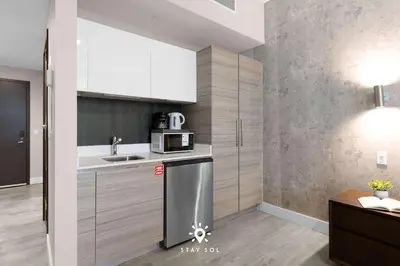 a kitchen with a sink and a microwave at Worth Traveling Hot tub & Unique Rooftop pool in Hollywood