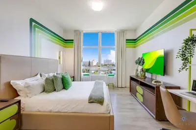 a bedroom with a bed and a large window at Rooftop Pool & Hot Tub Hollywood Beach Gym in Hollywood