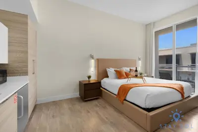 a bedroom with a bed and a large window at Hot tub & Unique Rooftop-Hollywood Broad-walk in Hollywood