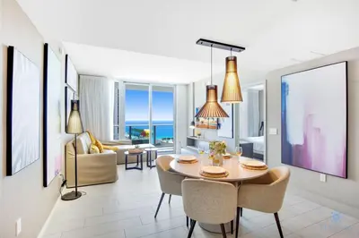 a dining room and living room with a table and chairs at Awesome Ocean View and Amenities, Pools - 2 BR in Hollywood