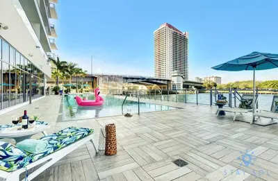 an outdoor patio with a pool and a building at Breathtaking Front Ocean View: Amazing Pools in Hollywood