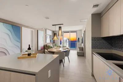 a kitchen and living room with a table and a counter at Breathtaking Front Ocean View: Amazing Pools in Hollywood