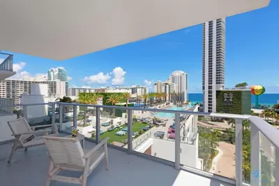 a balcony with chairs and a view of the ocean at Wrap Around Balcony-Awesome View-Amazing Pools in Hollywood