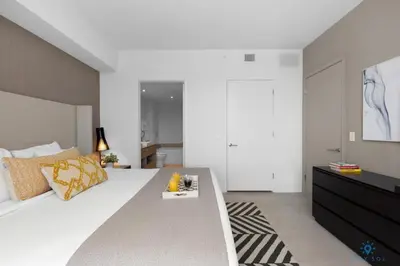 a bedroom with a large white bed and a television at Wrap Around Balcony-Awesome View-Amazing Pools in Hollywood