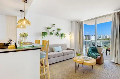 a living room with a couch and a table at Beachfront Resort Pool Ocean View Balcony Gym in Aventura