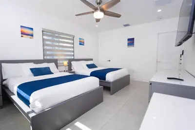 a bedroom with two beds and a ceiling fan at WALK to Hollywood Beach Spectacular 5BR and 5BA Villa in Hollywood