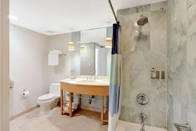 a bathroom with a sink and a shower at Beachfront with direct beach access and amazing views in Aventura