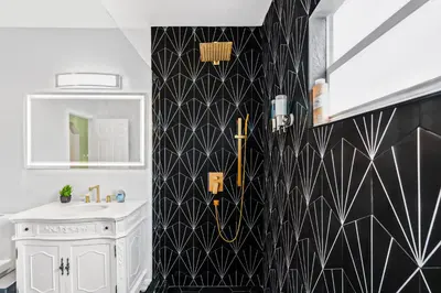 a bathroom with a sink and a black and white tiled wall at NEW! Havana Nights Villa ! Walk to Calle Ocho! in Miami