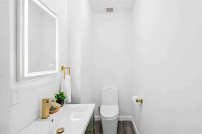 a white bathroom with a toilet and a sink at NEW! Havana Nights Villa ! Walk to Calle Ocho! in Miami
