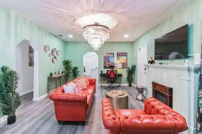 a living room with two leather couches and a fireplace at NEW! Havana Nights Villa ! Walk to Calle Ocho! in Miami