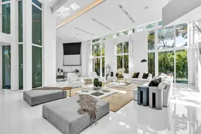 a living room with white furniture and large windows at Villa Loggia Oasis Luxurious 6BD ,7BA with Resort Style Pool in Golden Beach