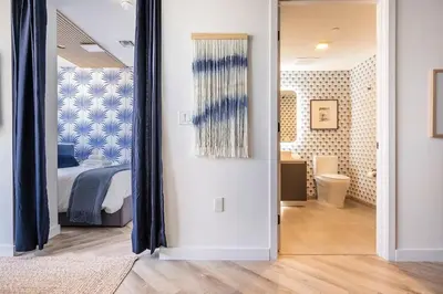 a bedroom with a bed and a mirror at Boutique Condo in DT Miami Perfect for Couples/Fam in Miami