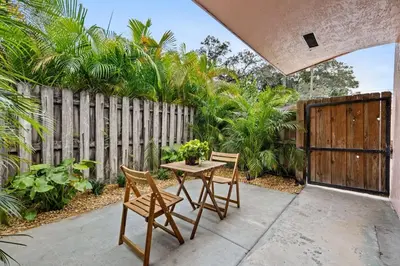 a patio with a table and chairs and a fence at Morning Sunshine @Sailboat Bend in Fort Lauderdale